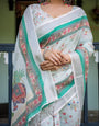 Ivory Pure Cotton Linen Saree with Elephant Motif and Floral Pattern, Green and Pink Borders, and Tassels on Edges.